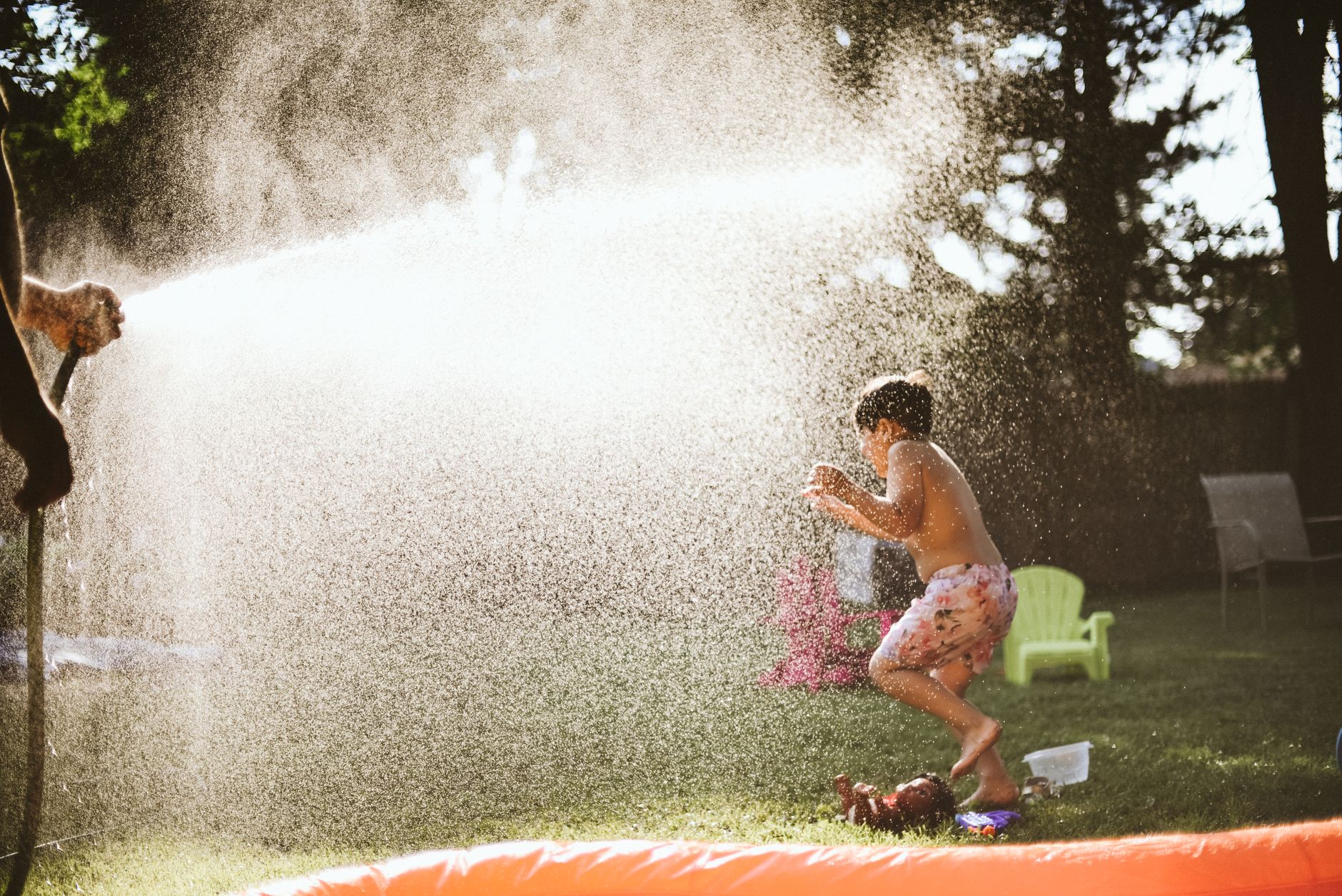 Children playing outdoors in a garden at Little Banyan