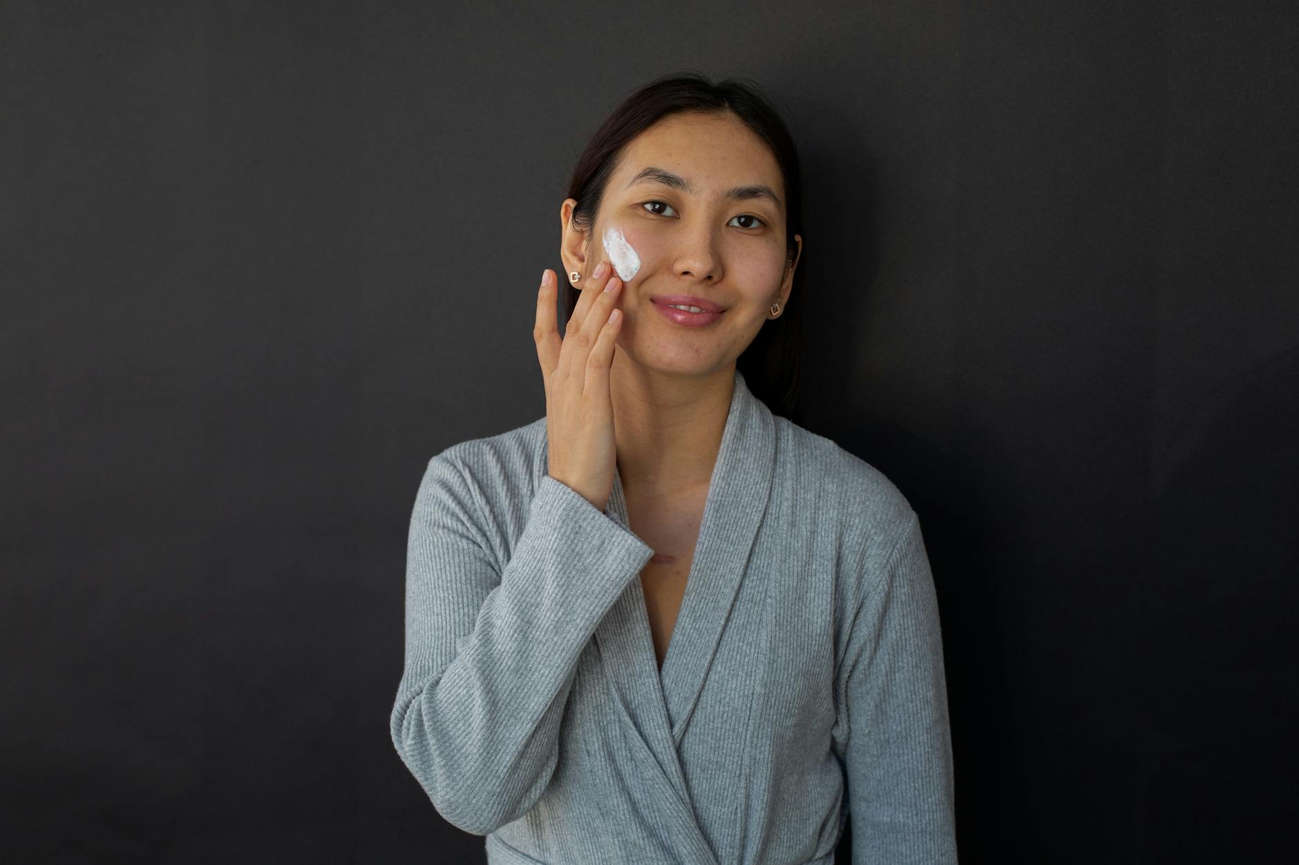 Woman applying skincare serum