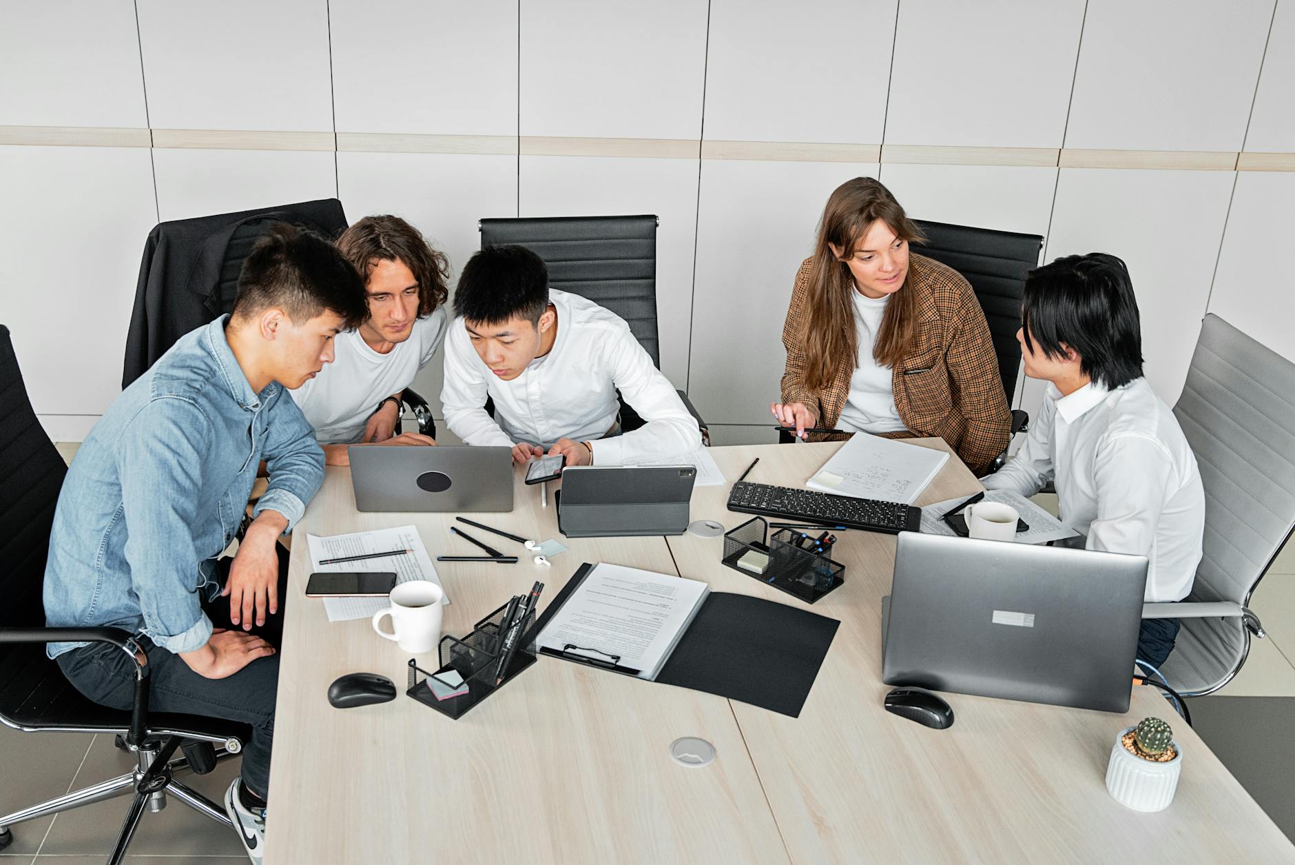 A Singapore team collaborating around a laptop