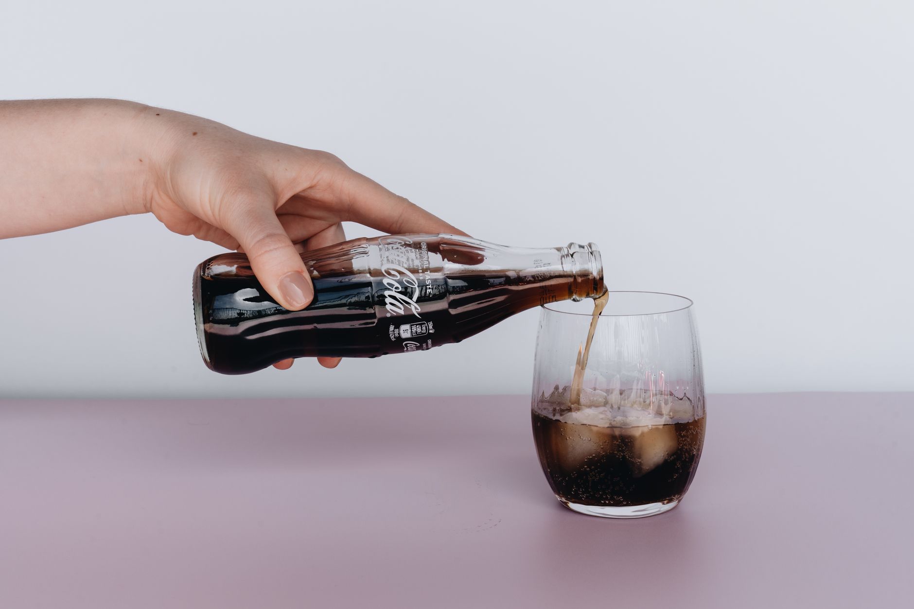 Pouring fizzy Boochly kombucha into a glass