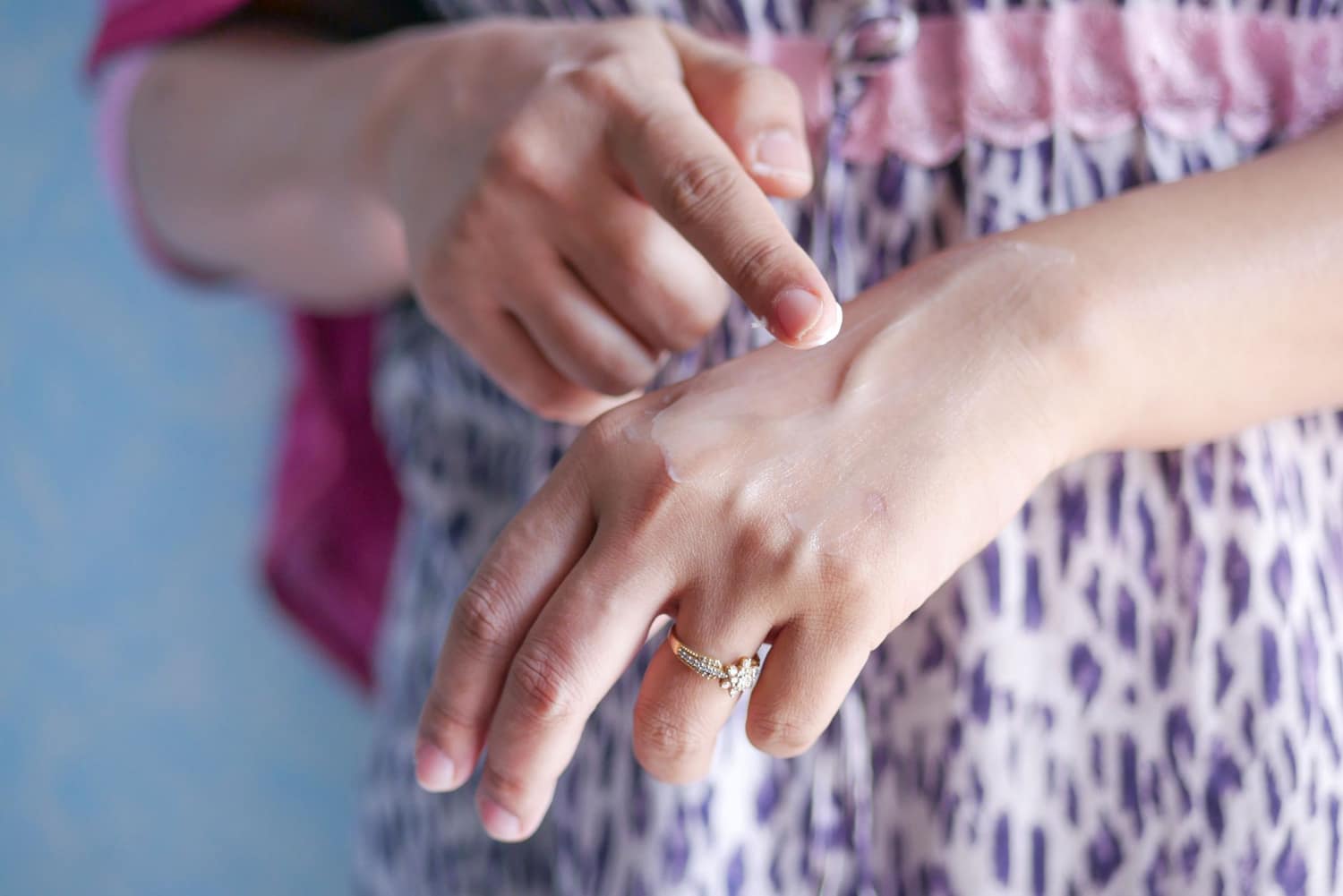 A parent moisturising their baby's skin