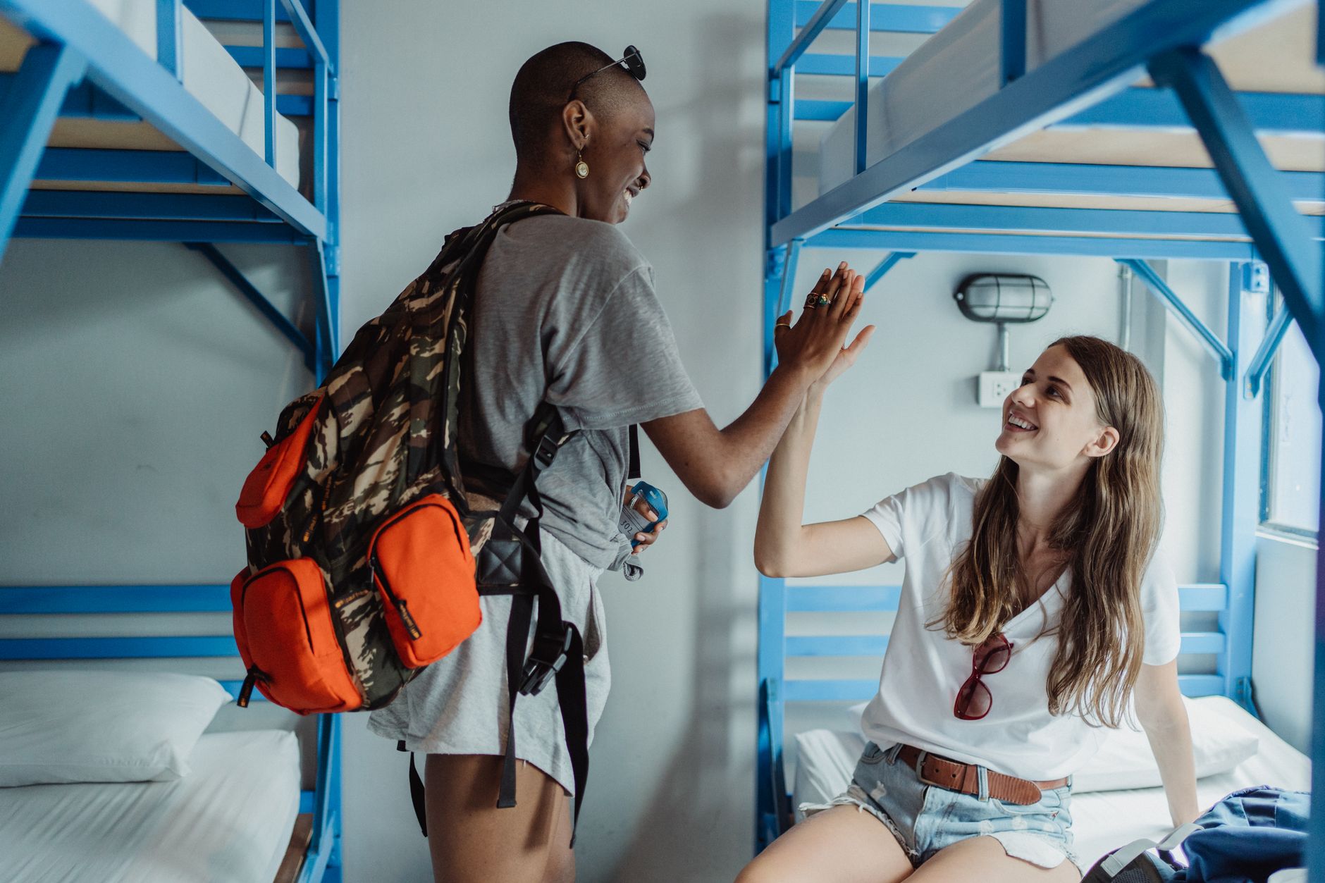 Backpackers laughing together in the Bunkmate common room