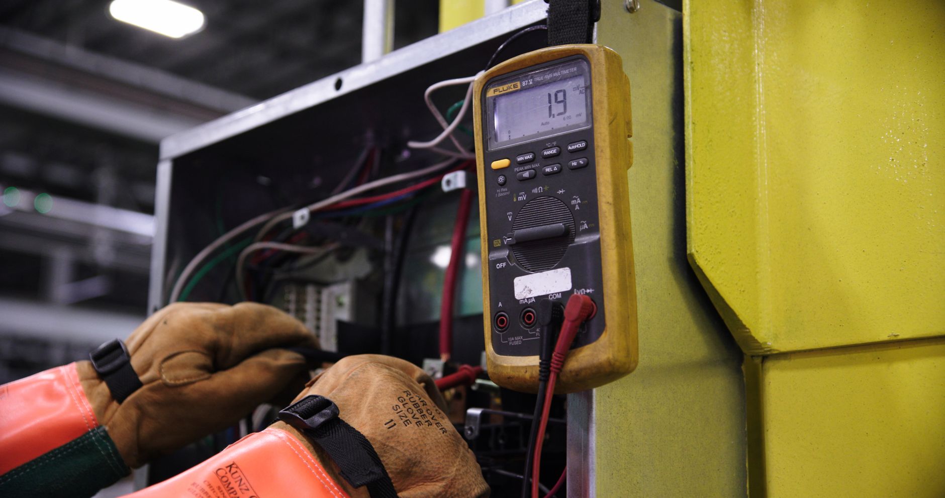 Technician testing an appliance with a multimeter