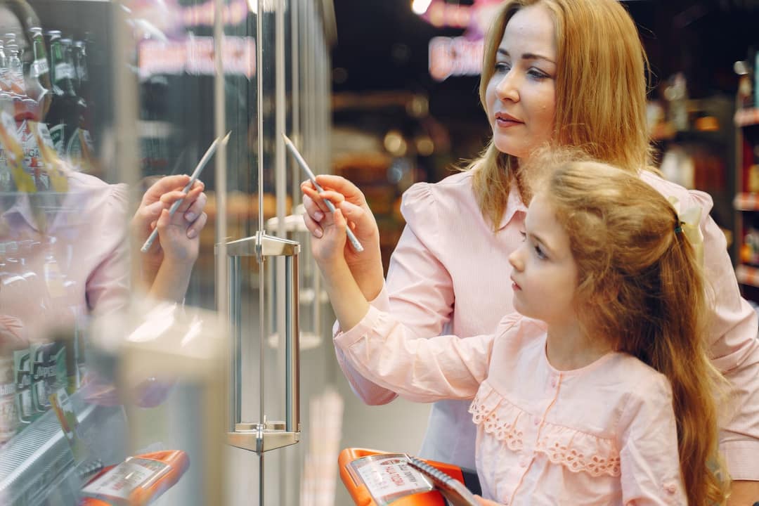 A parent and child choosing toys at Curio Kids