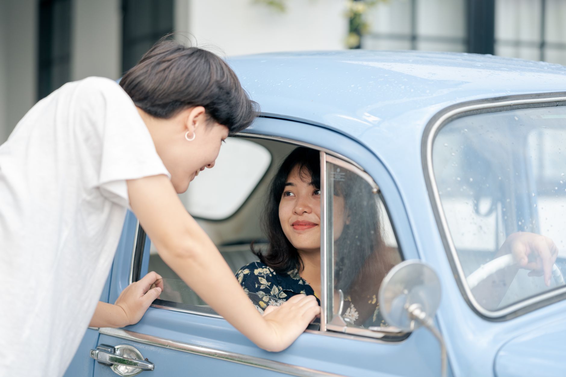 A relaxed Singapore driver behind the wheel of a well-insured car