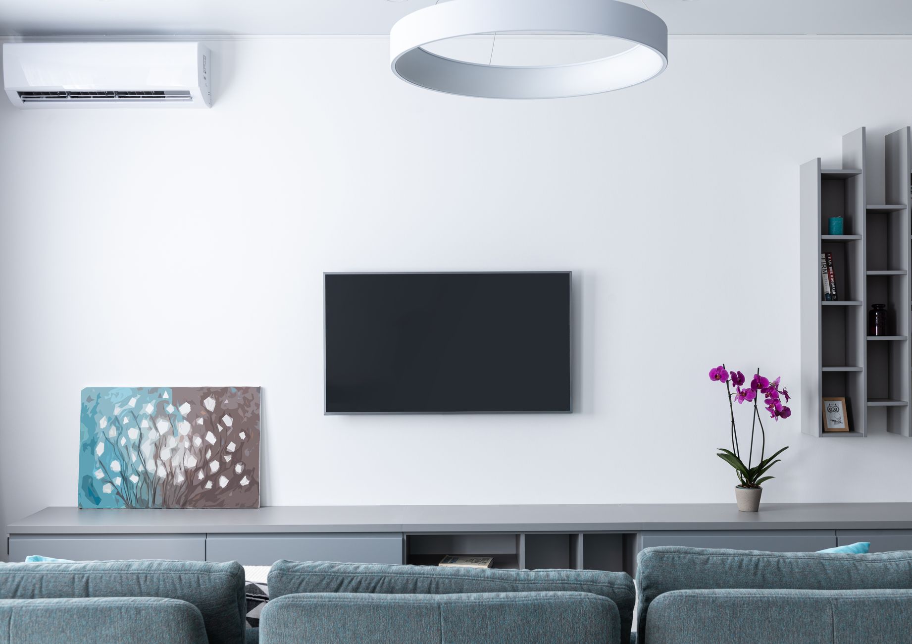 A cool, modern Singapore living room with a freshly serviced wall-mounted air conditioner