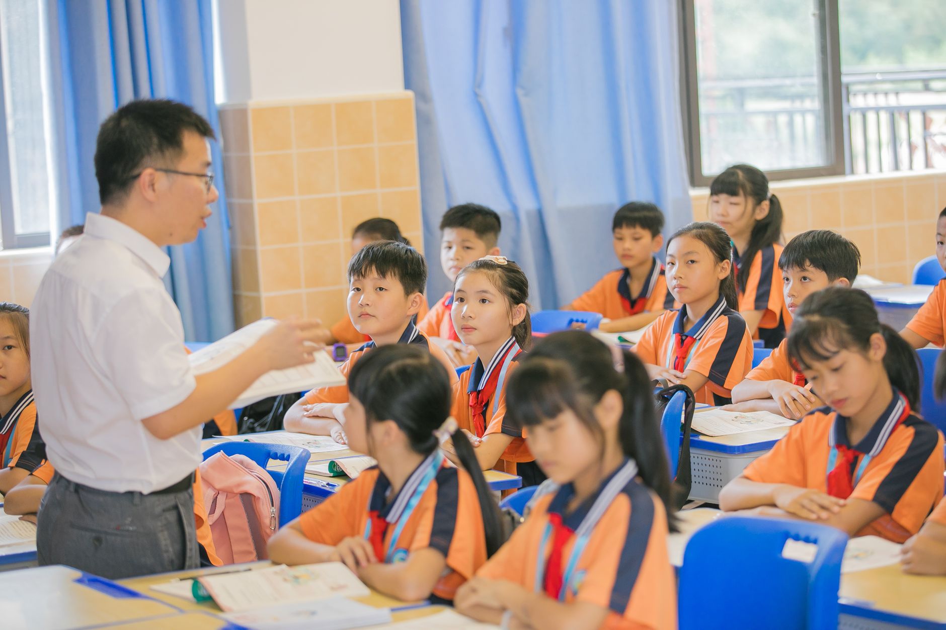 Children writing and reading together in a bright Inklings English classroom in Singapore