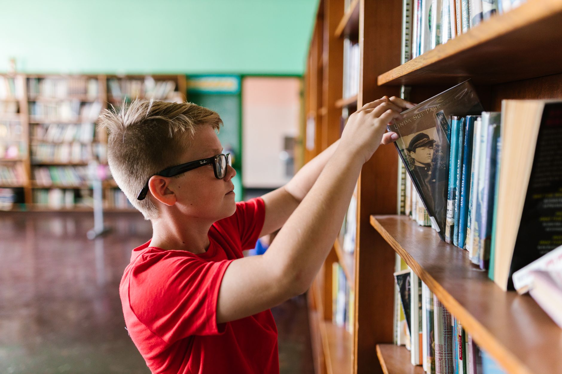 A child reading in the Inklings library corner