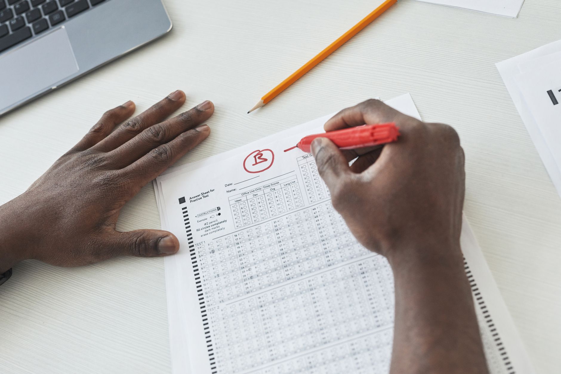 A teacher marking a student's writing at Inklings English