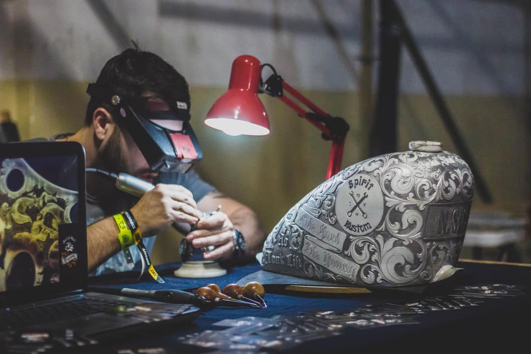Hand-engraving a leather keepsake in the workshop