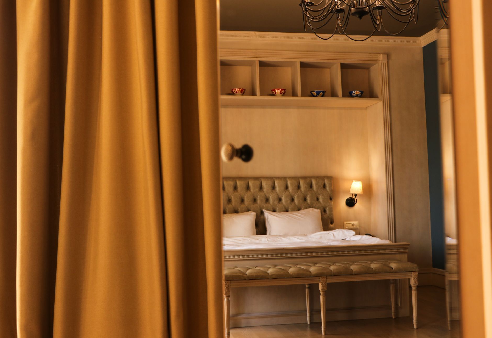 A warm heritage room with a reading lamp inside Kemala House