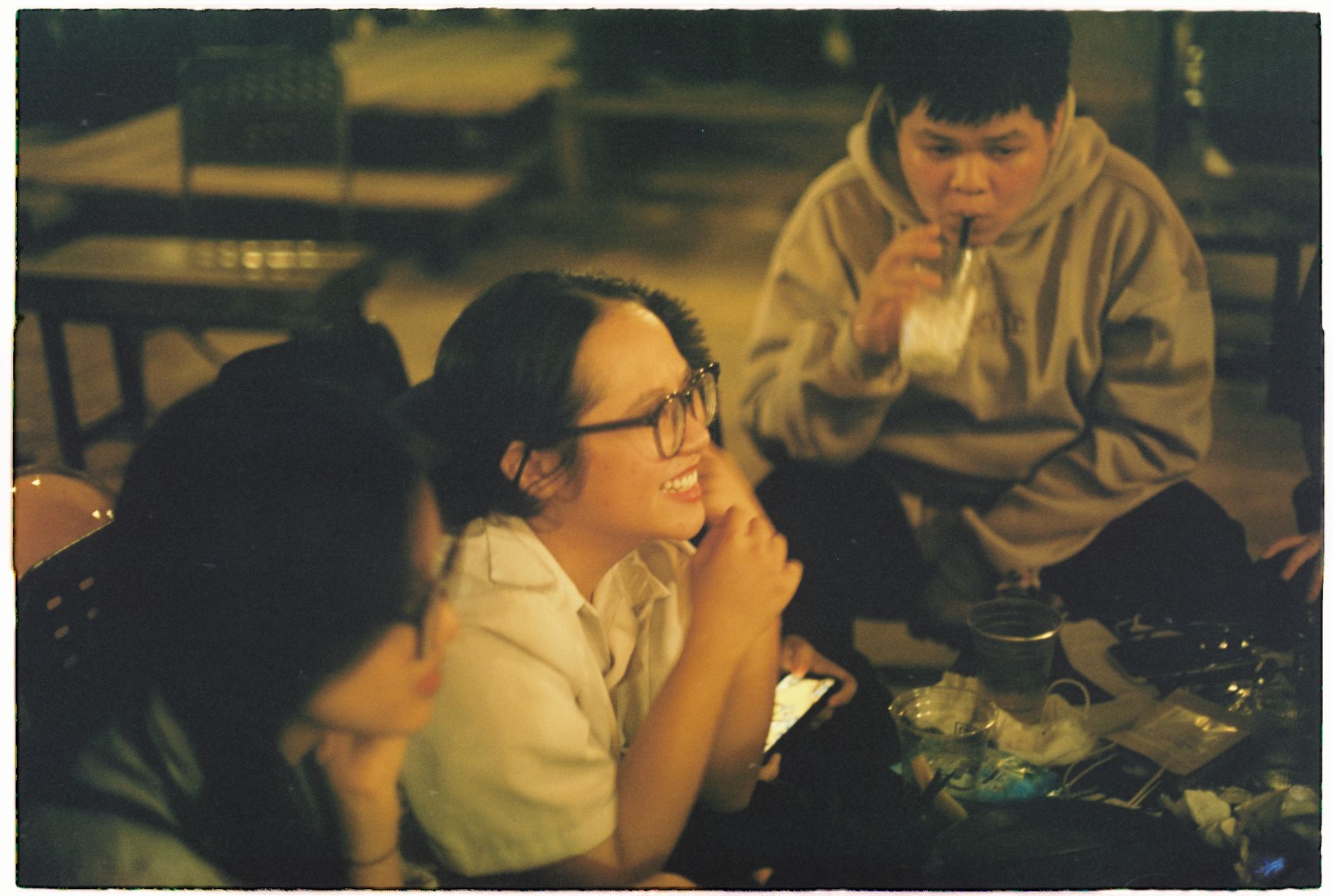 Members of a Singapore independents’ community talking and laughing together over coffee