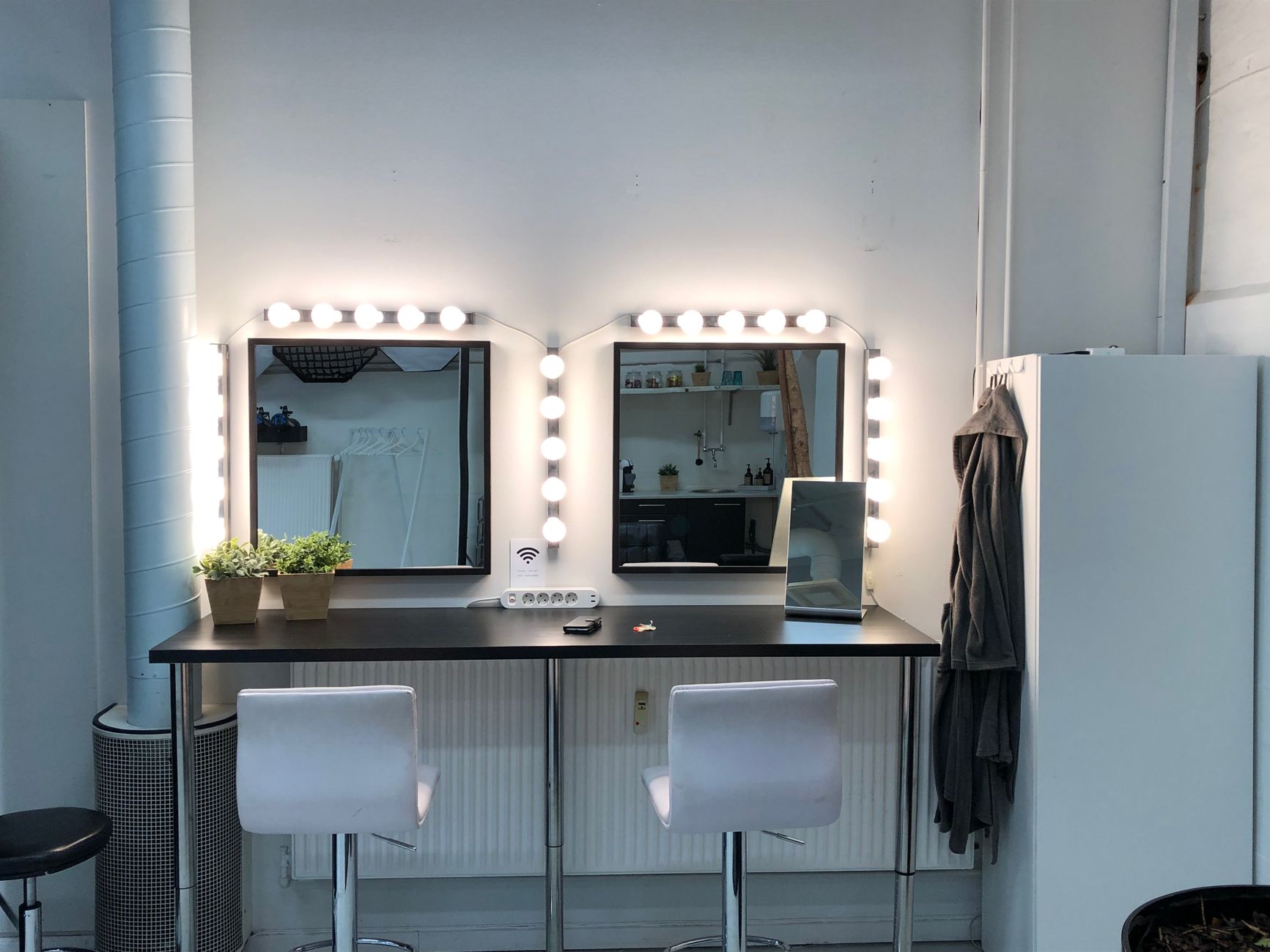 The Maison Belle teaching studio with vanity mirrors and lights
