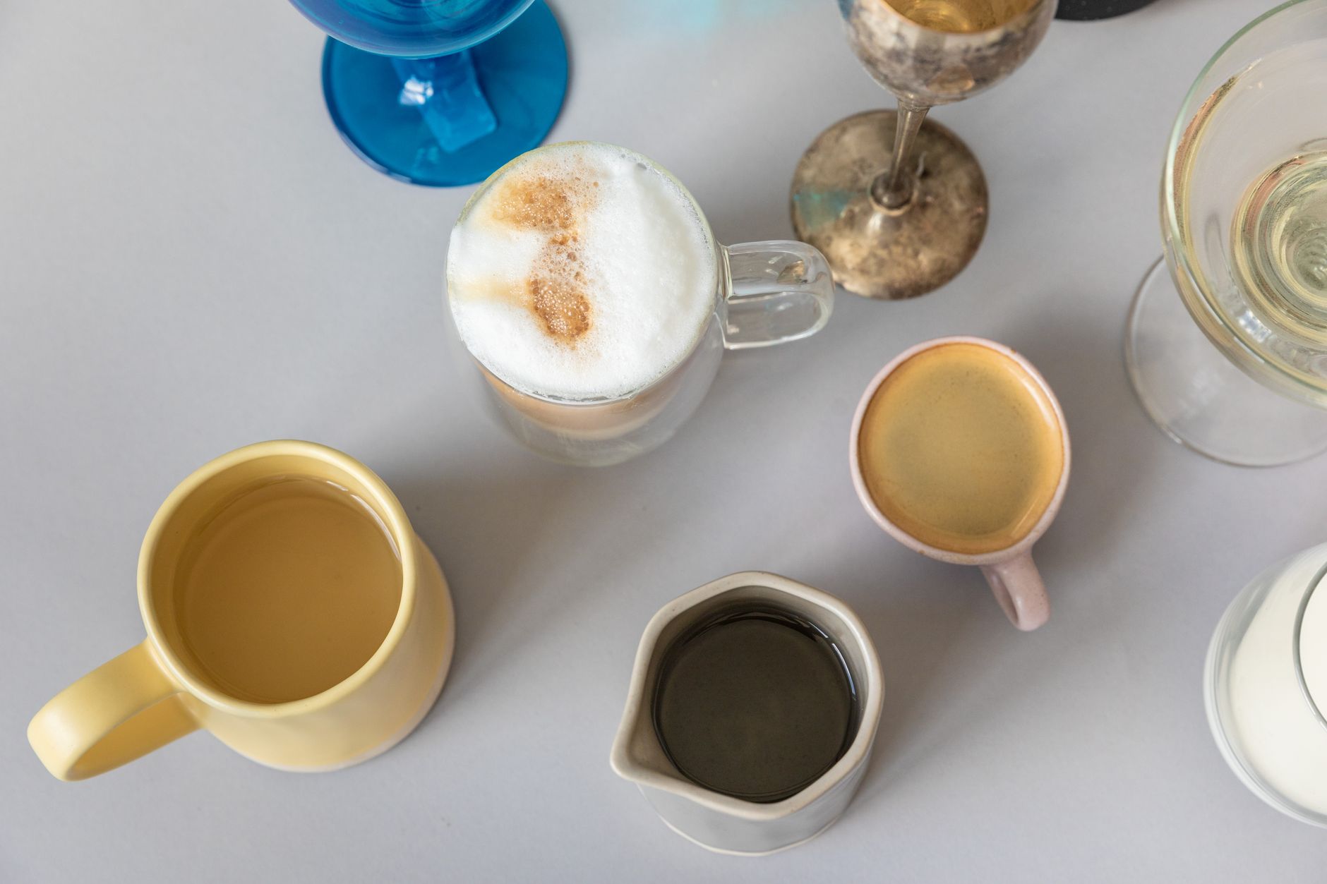 Assorted custom-printed ceramic mugs laid out flat