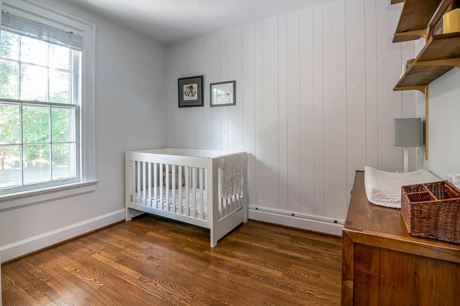 A solid-oak Nestwood cot in a finished nursery