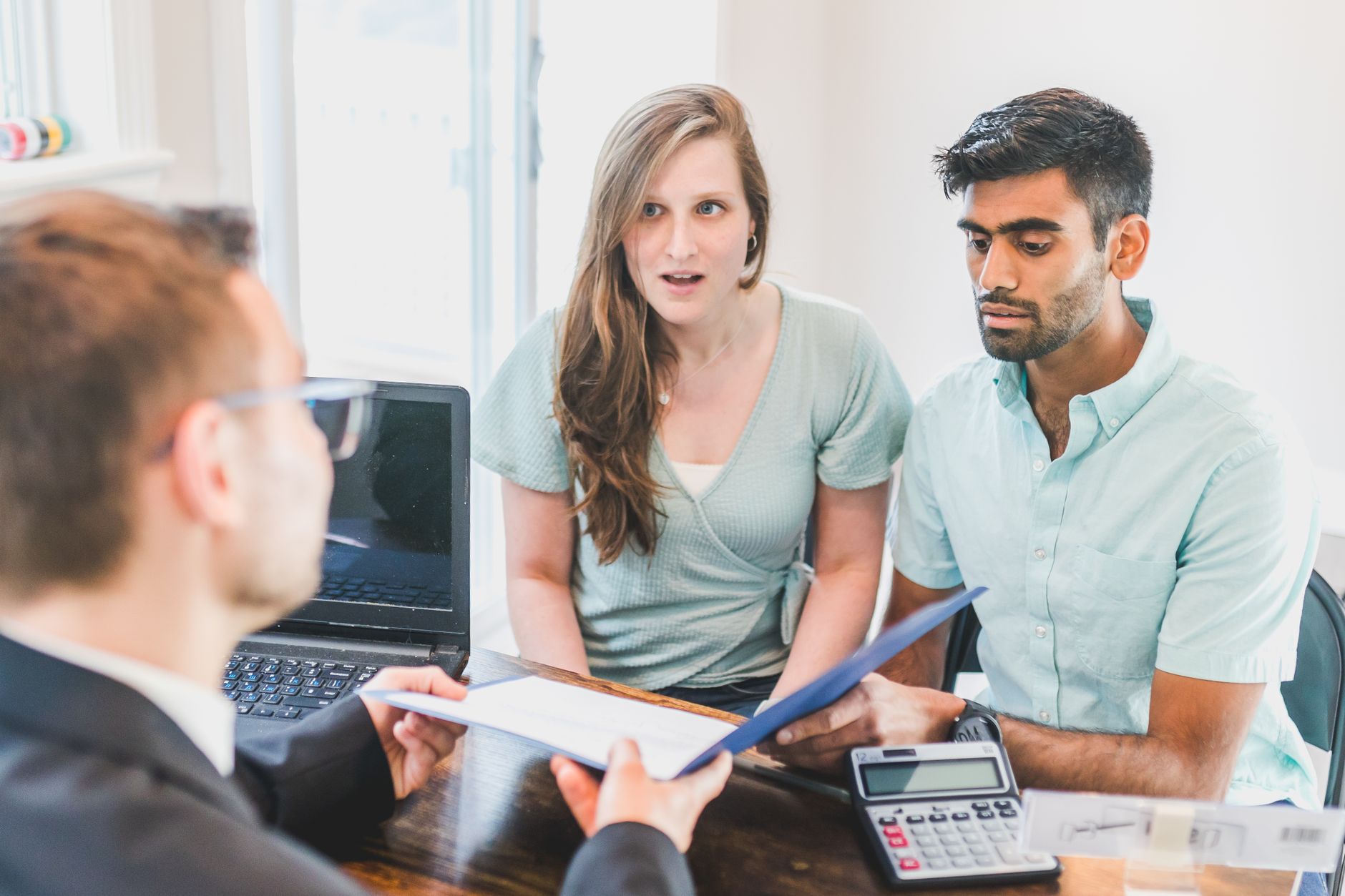 A Singapore couple in consultation with a Northcrest Global adviser