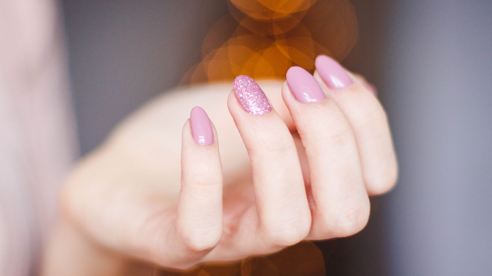 An elegant soft-pink almond manicure at a Petal & Polish nail studio in Singapore