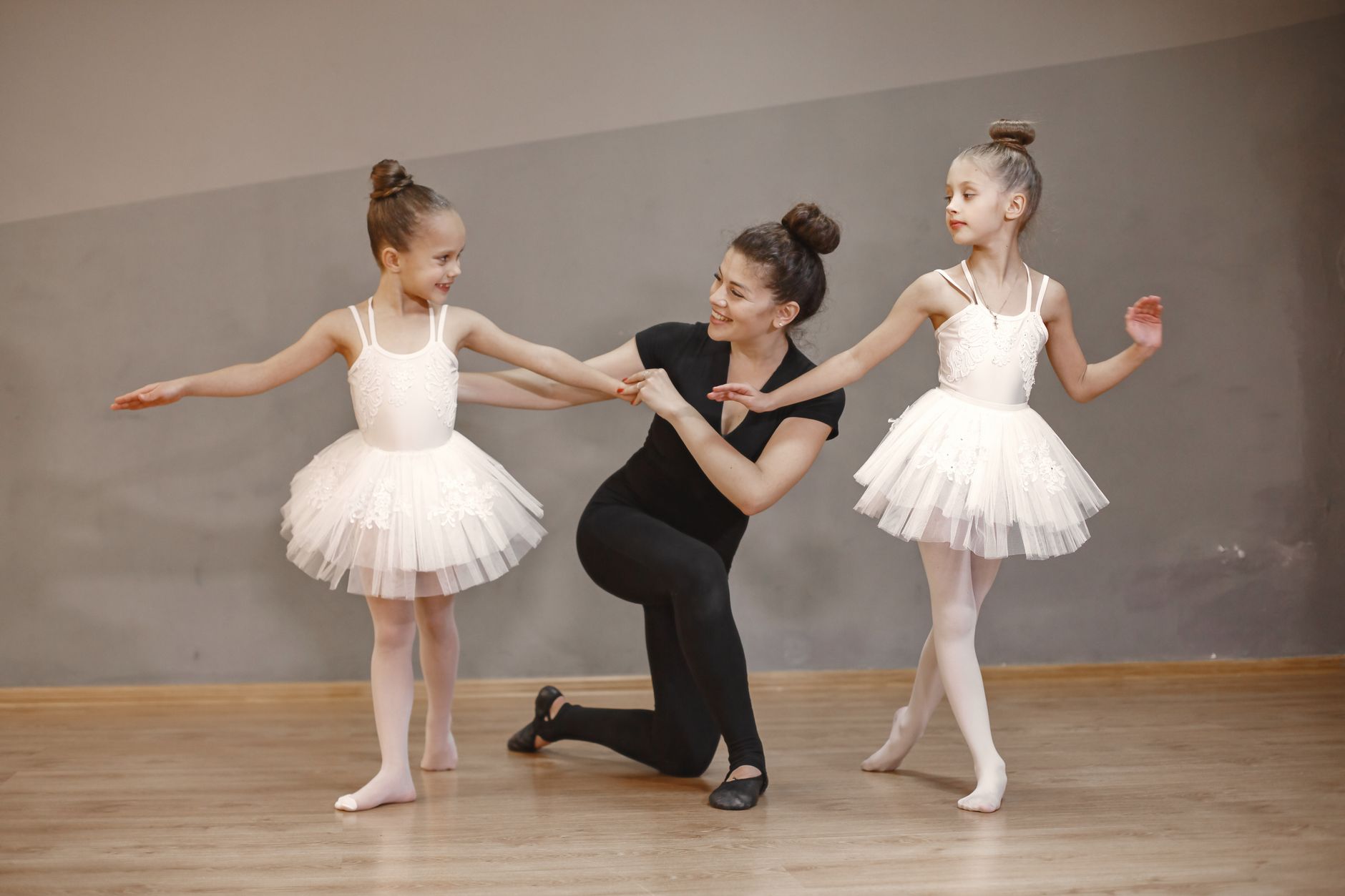 A dance teacher guiding a child in a Pirouette studio class