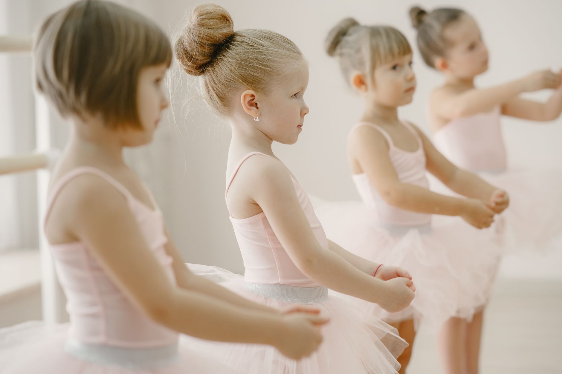 Young ballet dancers at the barre in a bright Singapore studio