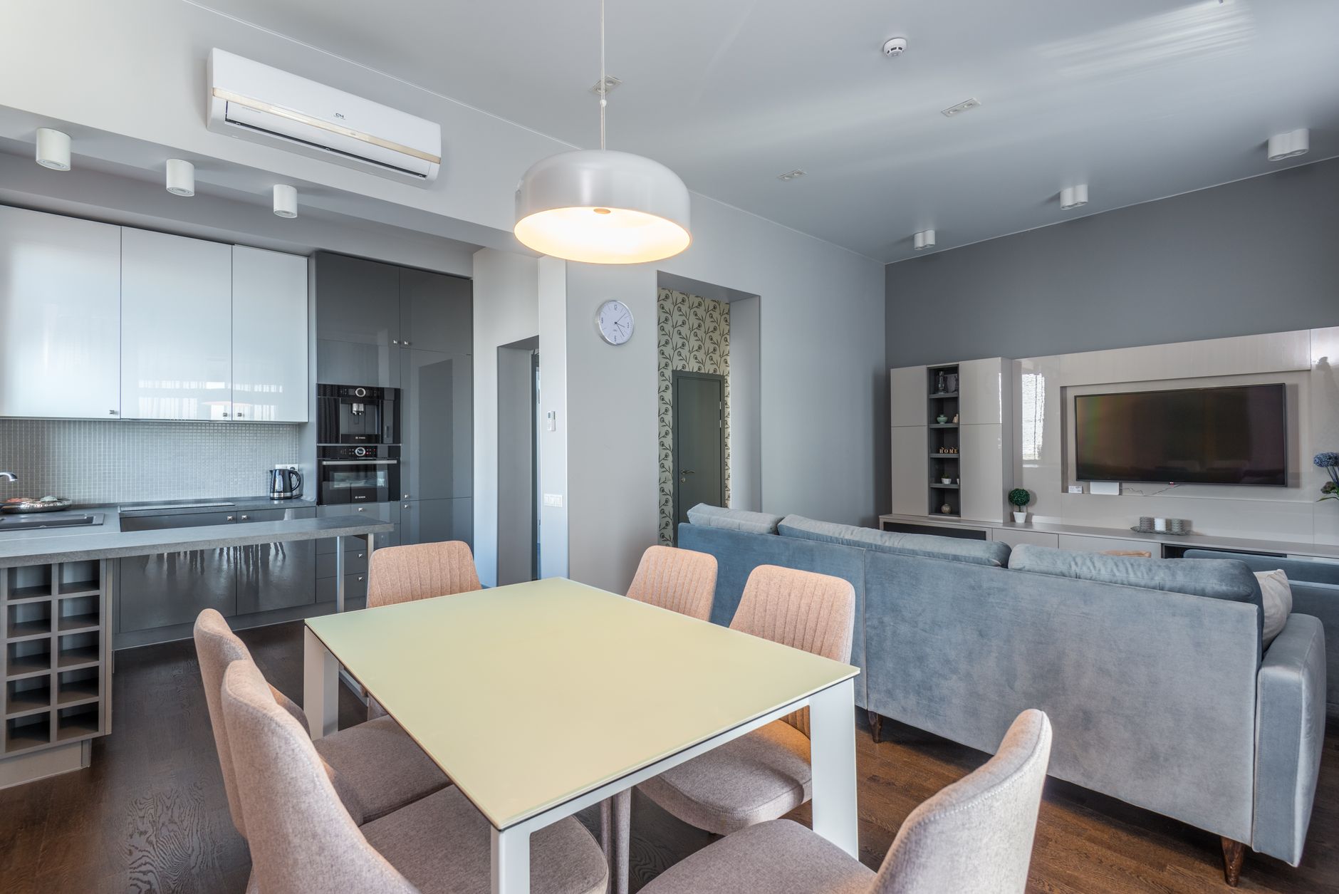 A bright, freshly deep-cleaned Singapore living room with a sparkling wall-mounted air conditioner