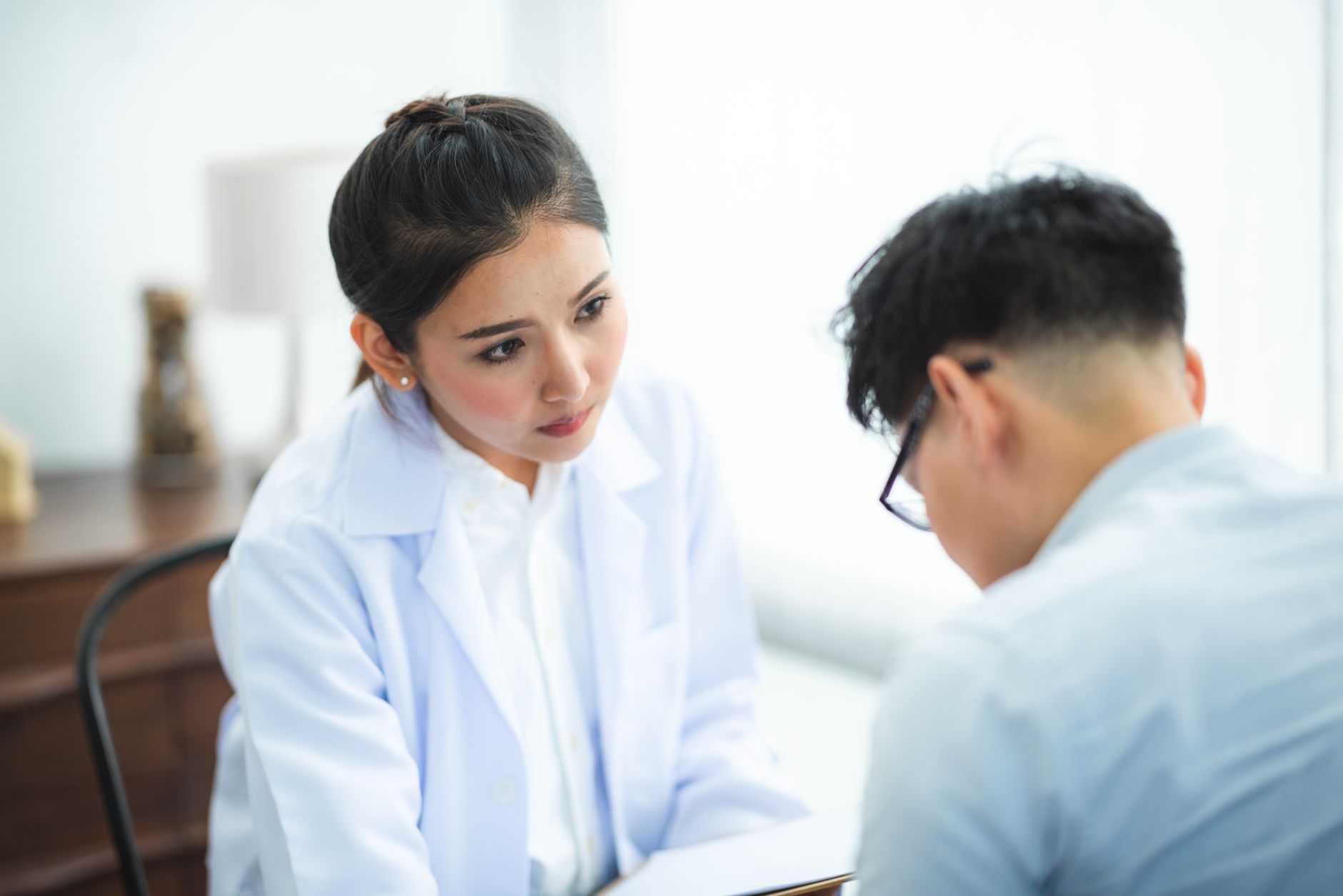A doctor consulting with a patient at Rootwell Hair Clinic