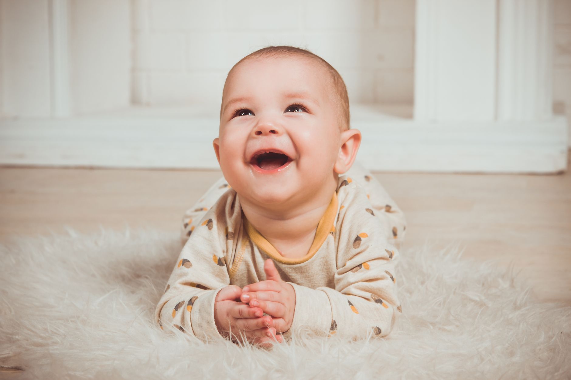 A baby in a colourful cloth nappy