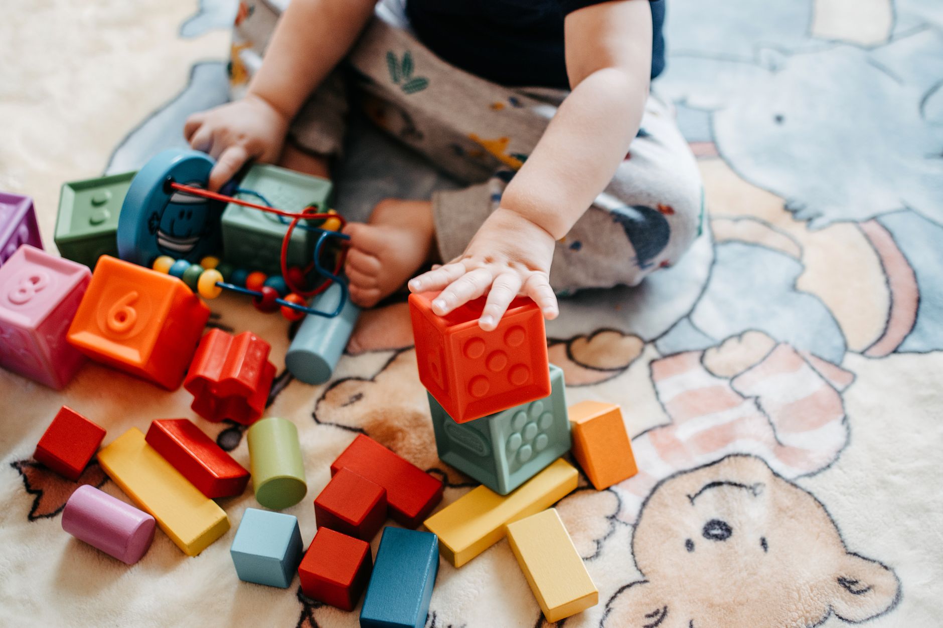 A toddler playing in a bright nursery