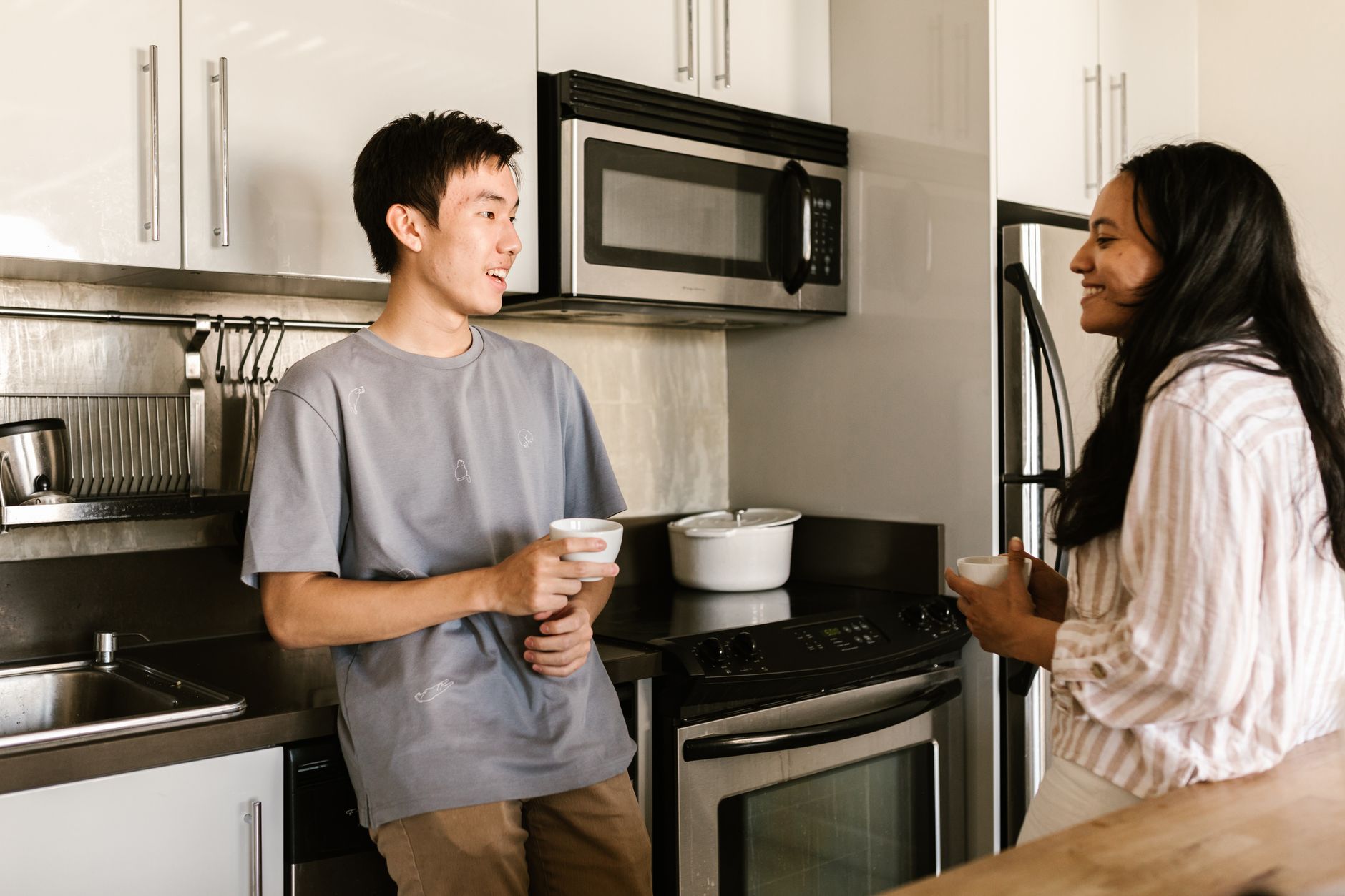 Housemates cooking together in a Stack Living kitchen