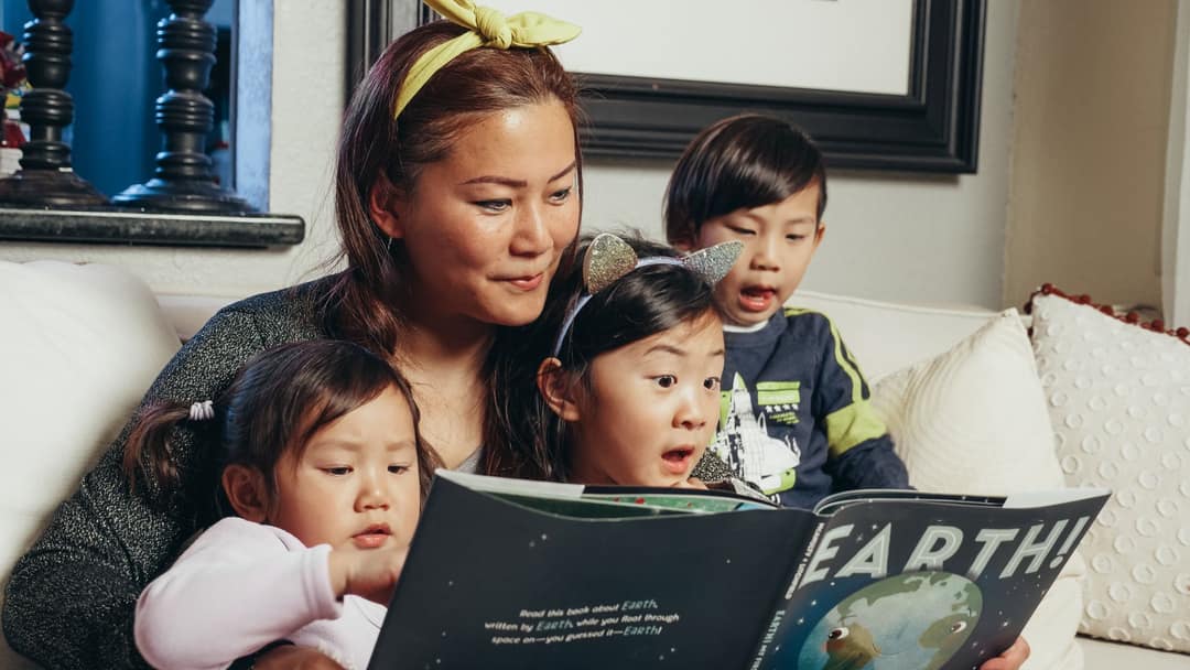 A parent reading a book to a child