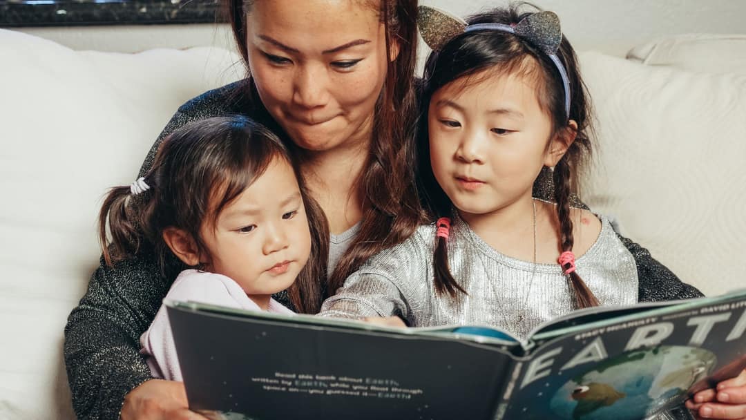 A parent and child choosing books at Storynest