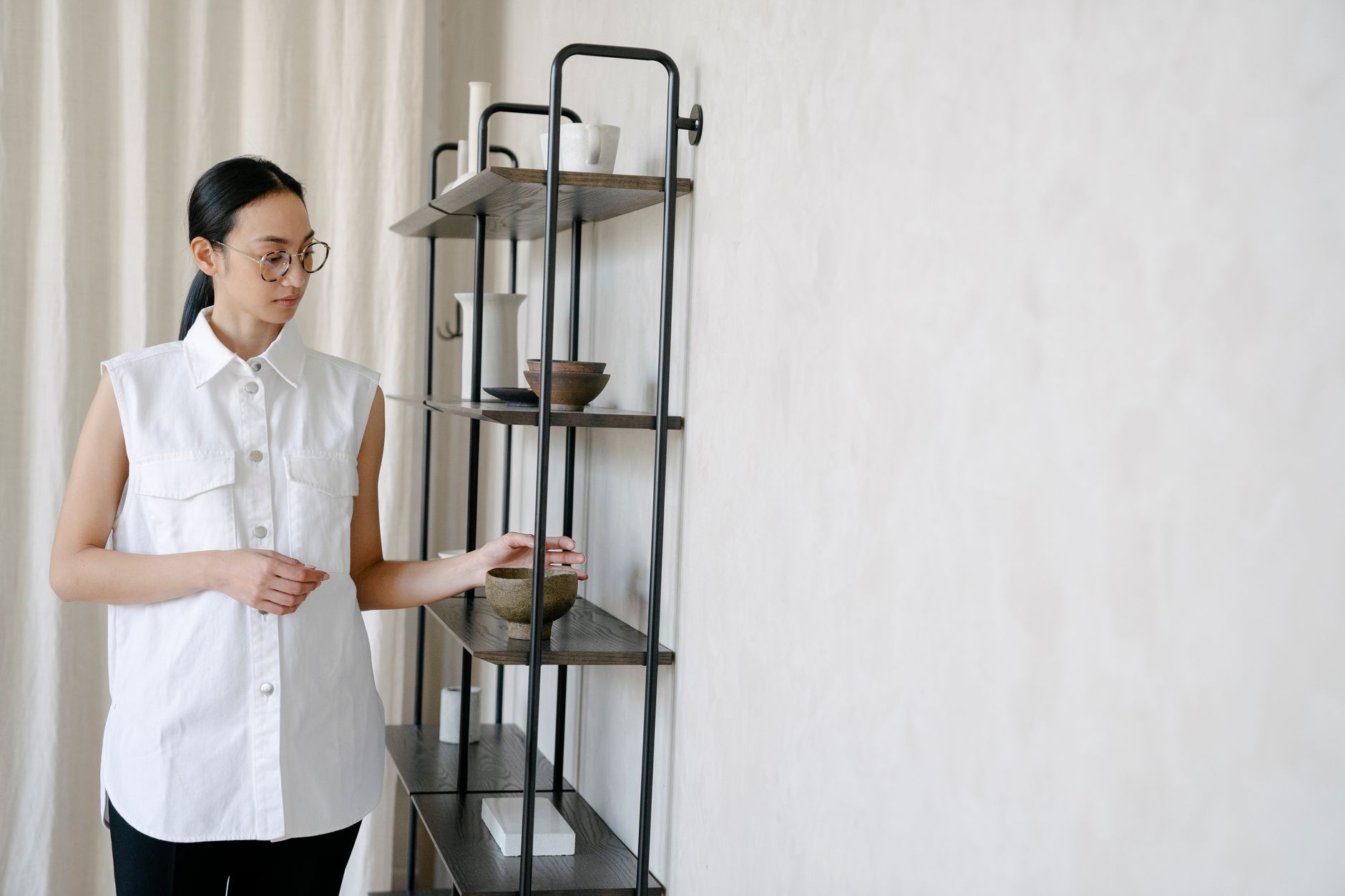 Cheryl Ang styling a shelf in a client's Singapore home