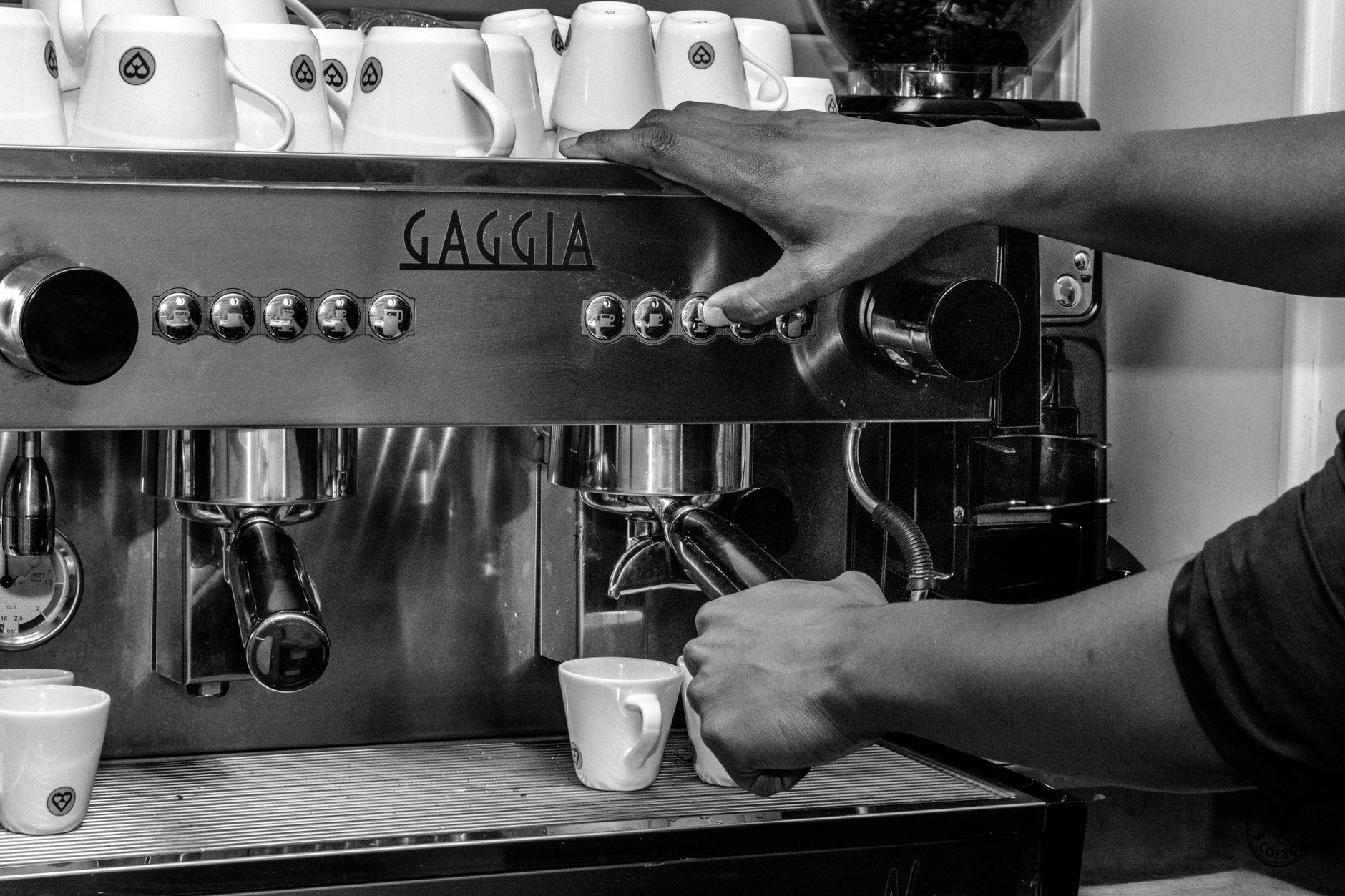 A barista pulling an espresso shot at the Subtext Coffee bar