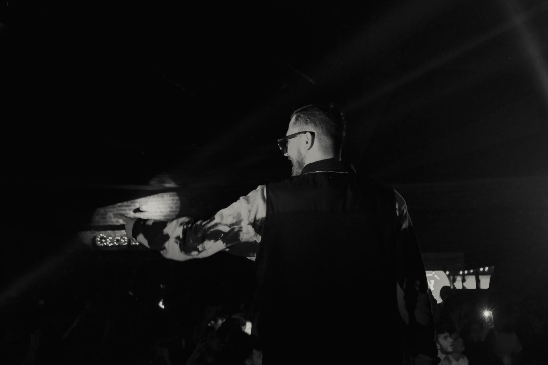 Sufyan Halim hosting an event on stage with a microphone