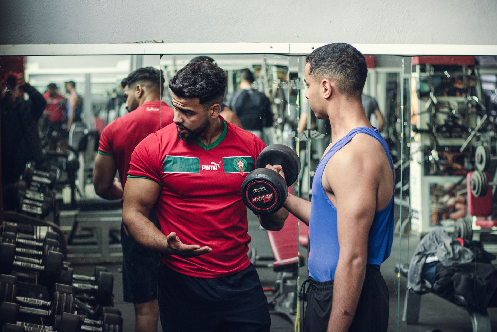A coach working a member through a lift at Volt Strength
