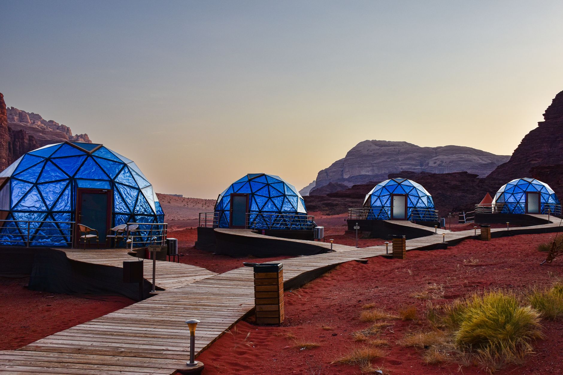 A geodesic dome glowing at dusk at Wildnest