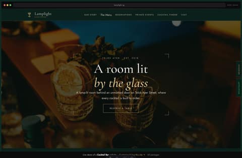 Lamplight cocktail bar Singapore website homepage demo — a deep-emerald art-deco site with a framed dark-photo hero, brass nav and signature drink cards