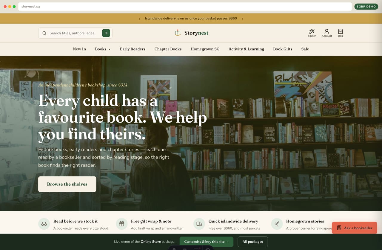 Storynest kids' bookshop online store homepage demo — warm promo strip, centered wordmark, full-bleed bookshop hero (Singapore)