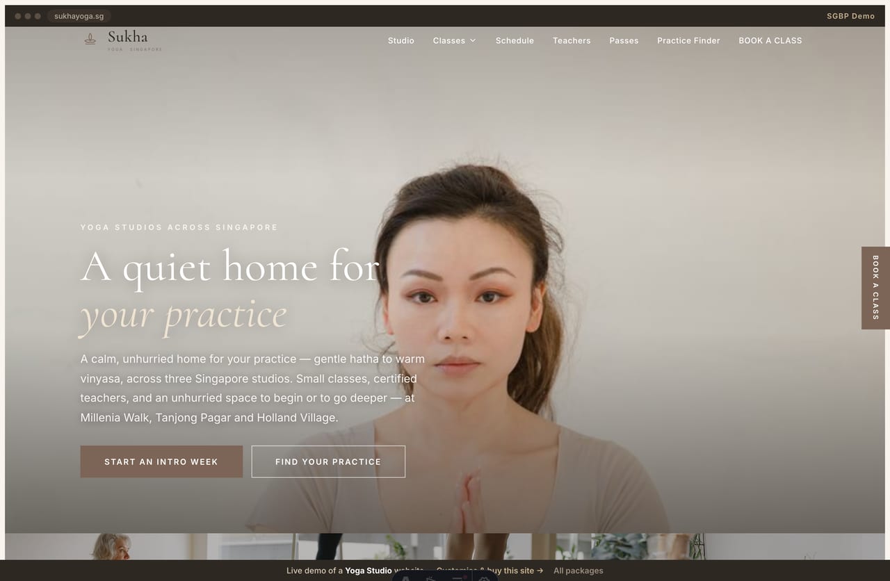 Sukha yoga studio Singapore website homepage demo — a cream and earthy-brown site with a full-bleed pose hero, sharp-cornered buttons and a serene editorial layout