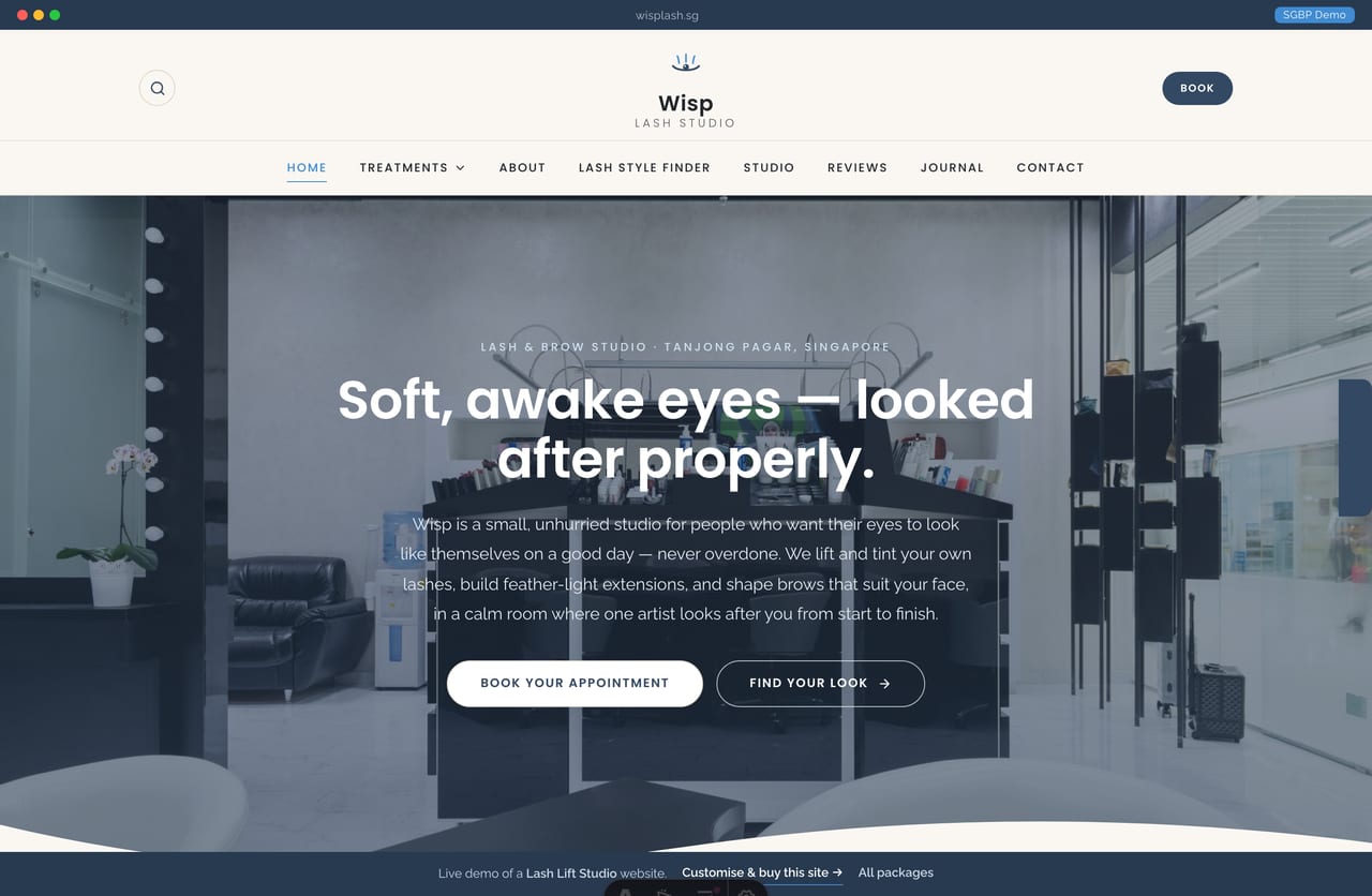 Wisp lash lift studio Singapore website homepage demo — a full-bleed studio-photo hero with a wave divider, a calm slate-and-cream layout and a centered wordmark